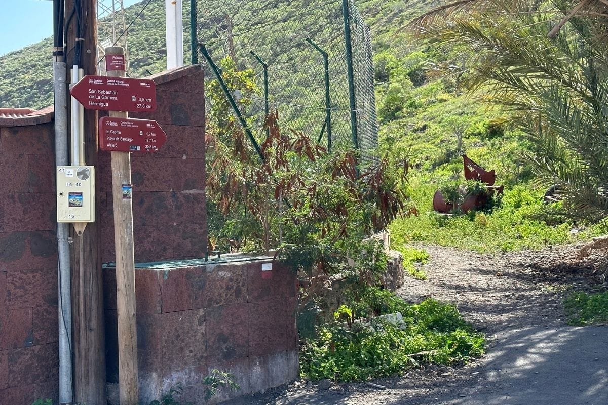 Start Of Walking Trail Shows Sign Post And Metal Fence With Path To Side Hiking To Playa De La Guancha From San Sebastian Canary Islands Spain