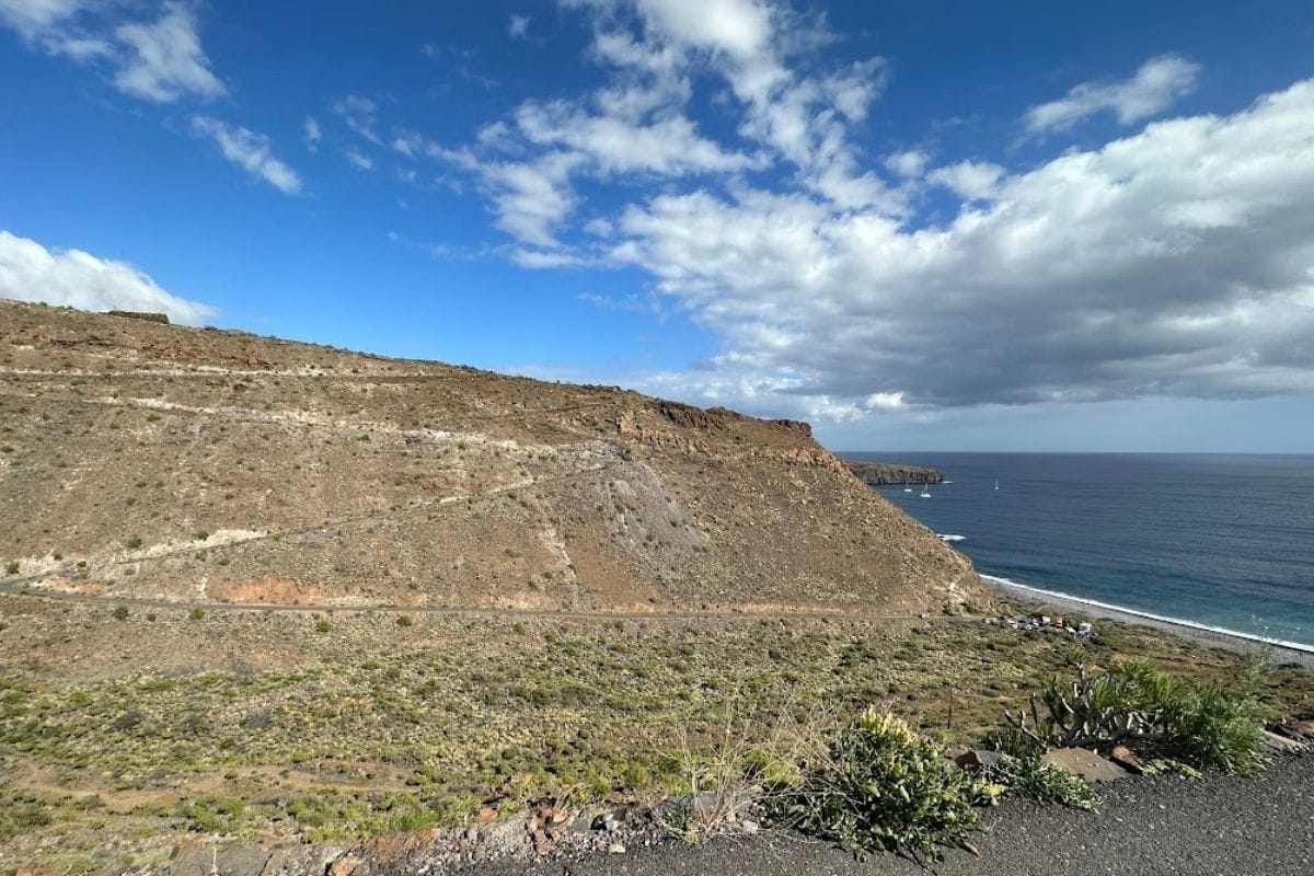 Hiking Trail Up Cliffside To Playa de Chinguarime La Gomera Canary Islands Spain With Blue Sea And Beach In Background