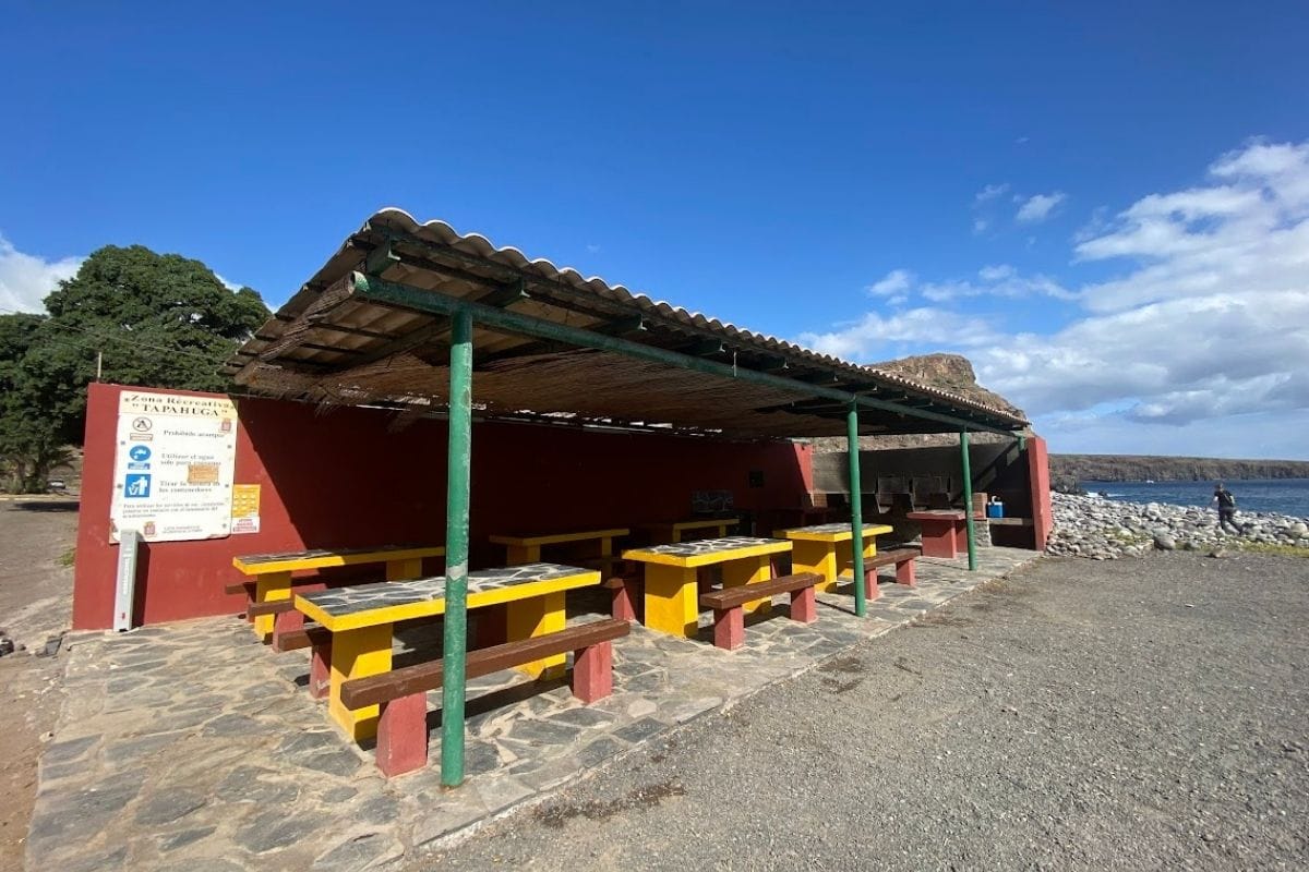 Cooking And BBQ Area At Playa de Tapahuga La Gomera Canary Islands Spain With Rocky Beach And Sea In Background