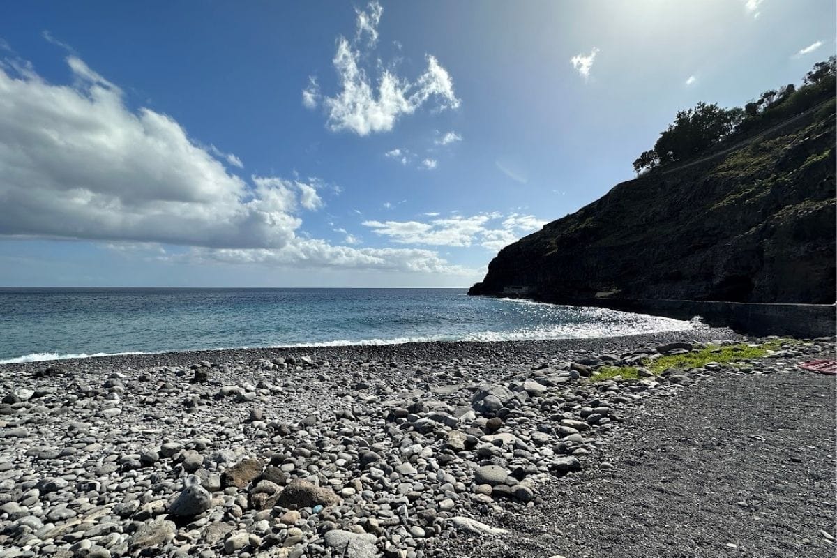 Rocky Beach And Blue Sea At Playa de Tapahuga La Gomera Canary Islands Spain With Old Harbour Wall In Background