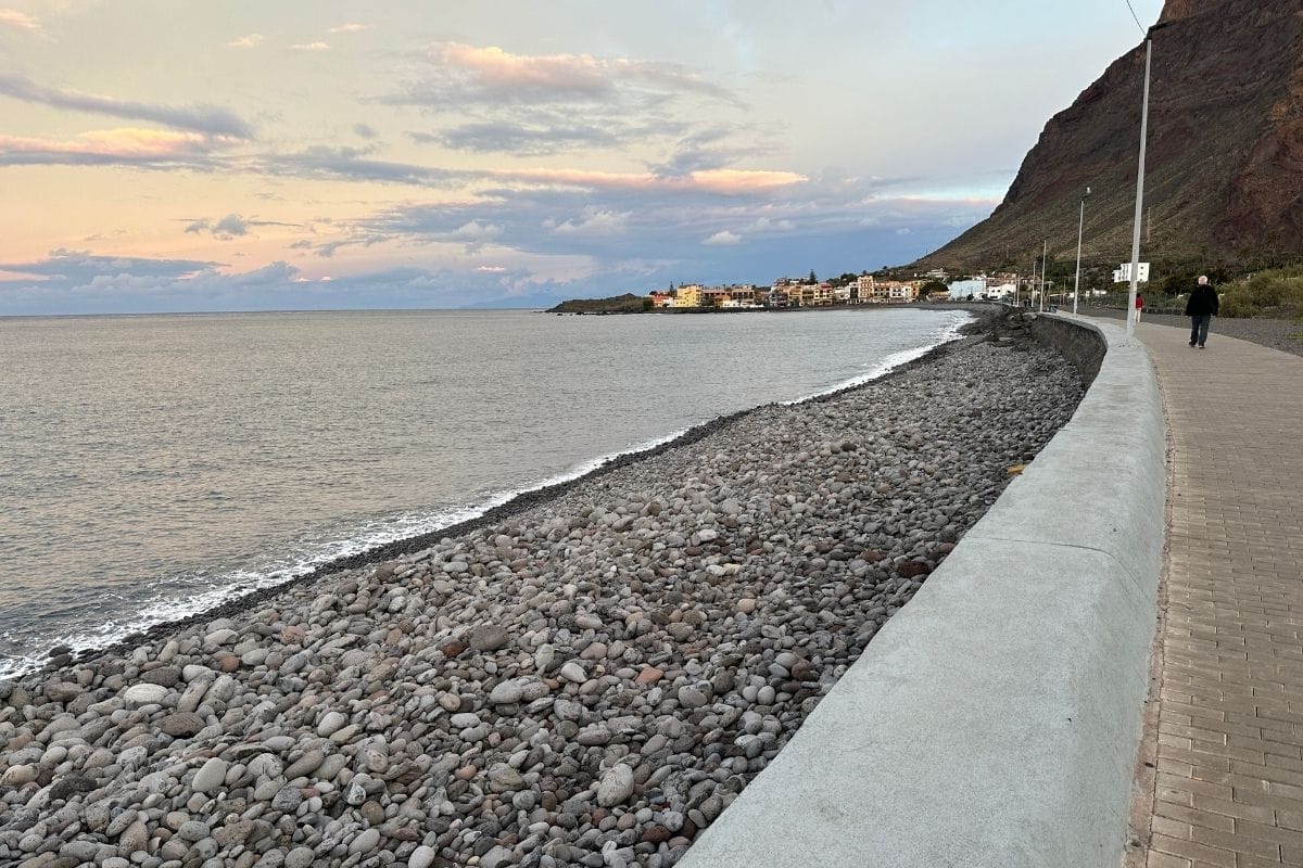 A Long Thin Pebbled Beach At Sunrise With Restaurants In The Background Called Playa De Valle Gran Rey La Gomera Canary Islands Spain