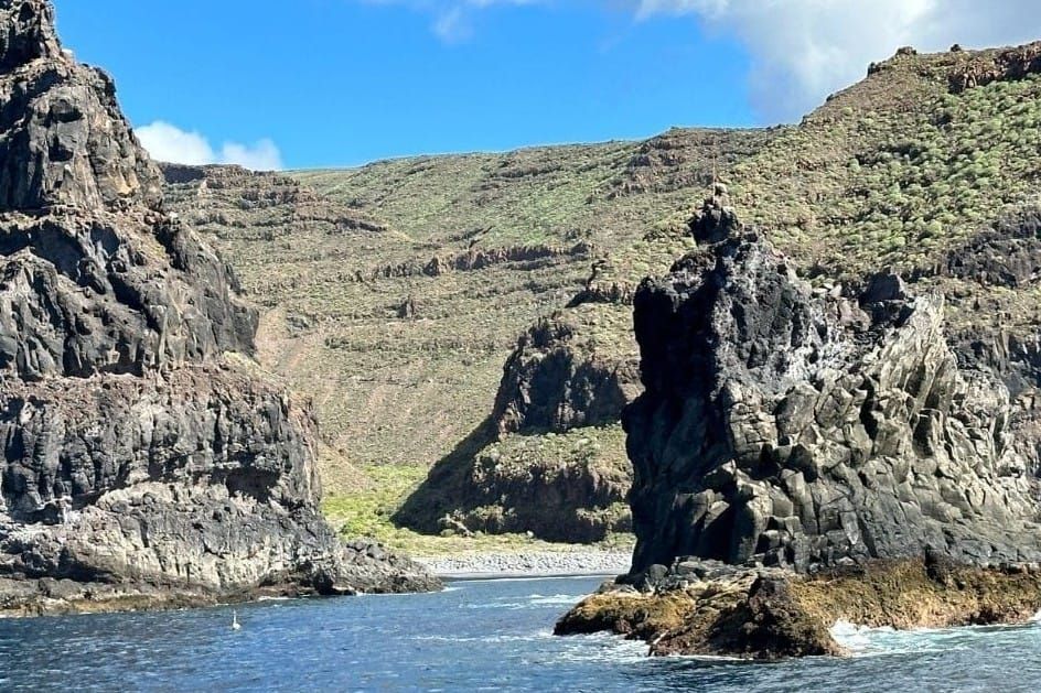 Blue Sea And Rock Formations In Front Of Playa De Iguala La Gomera Canary Islands Spain With Steep Mountains In The Background