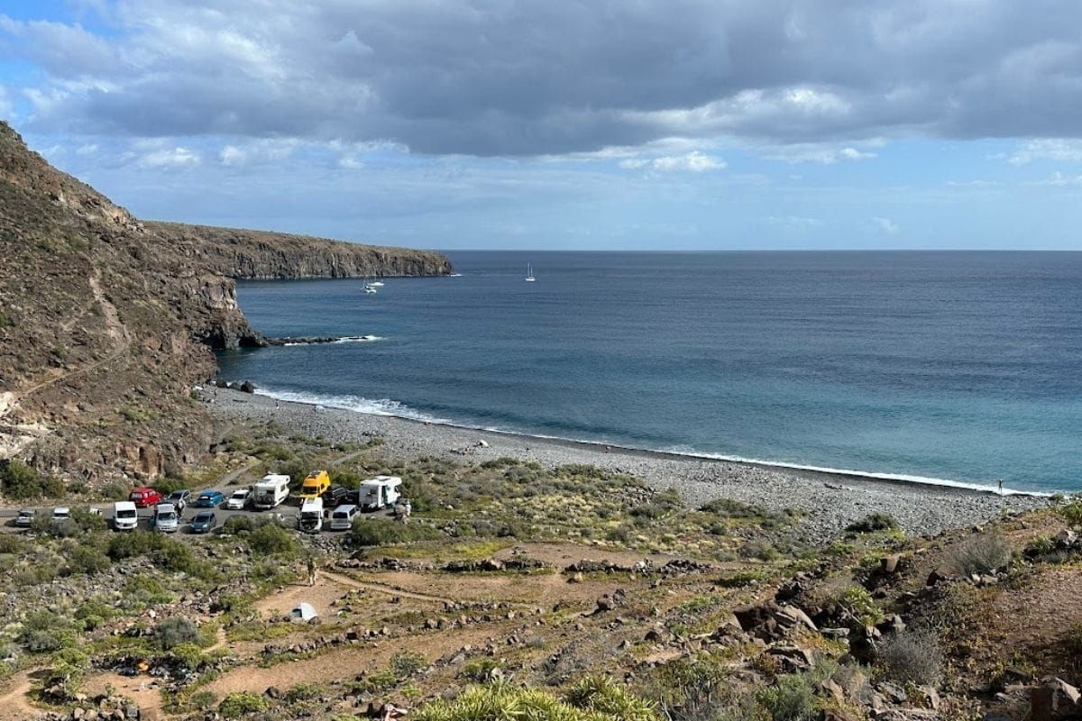 Footpath To Playa Del Medio La Gomera Canary Islands Spain Taken On Sunny Day With Blue Sky And Blue Sea Also Shows Cars