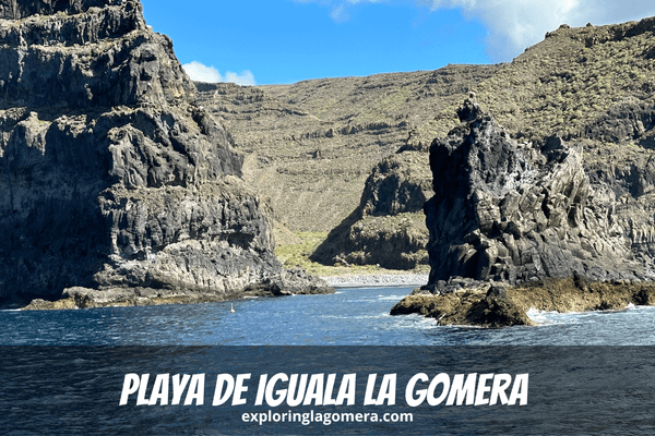 Blue Sea And Rock Formations In Front Of Playa De Iguala La Gomera Canary Islands Spain With Steep Mountains In The Backgroun