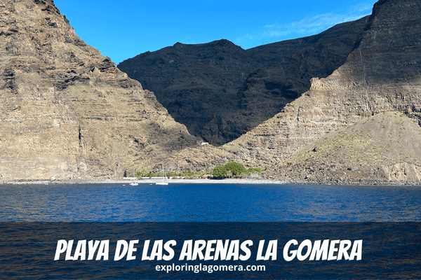 Blue Sea And A Sandy Beach Known As Playa De Las Arenas La Gomera Canary Islands Spain With Mountains In The Background
