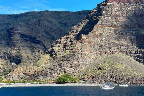 Blue Sea And A Sandy Beach Known As Playa De Las Arenas La Gomera Canary Islands Spain With Mountains In The Background