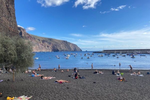 People Sit On The Beach And Swim On Playa De Vueltas La Gomera At Valle Gran Rey Canary Islands Spain