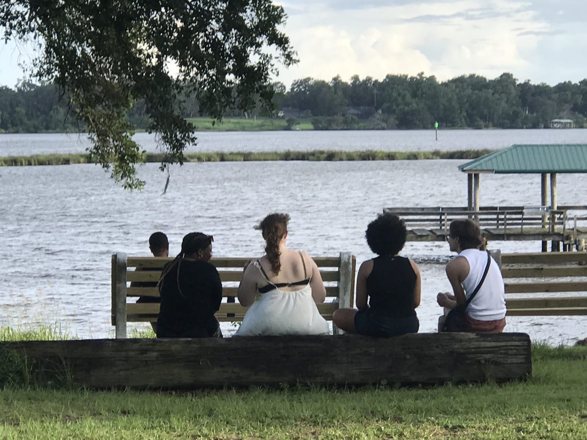 students sitting by the water