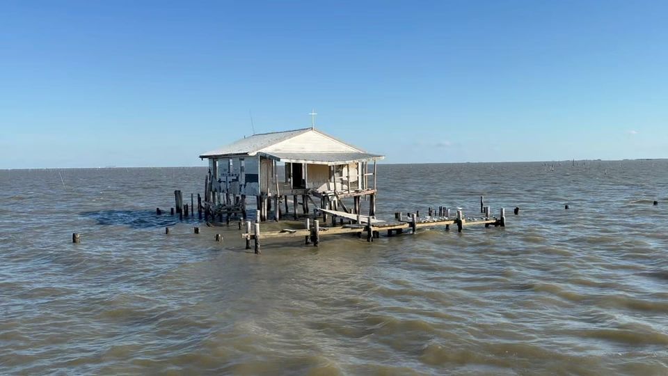 a house on stilts surrounded by water