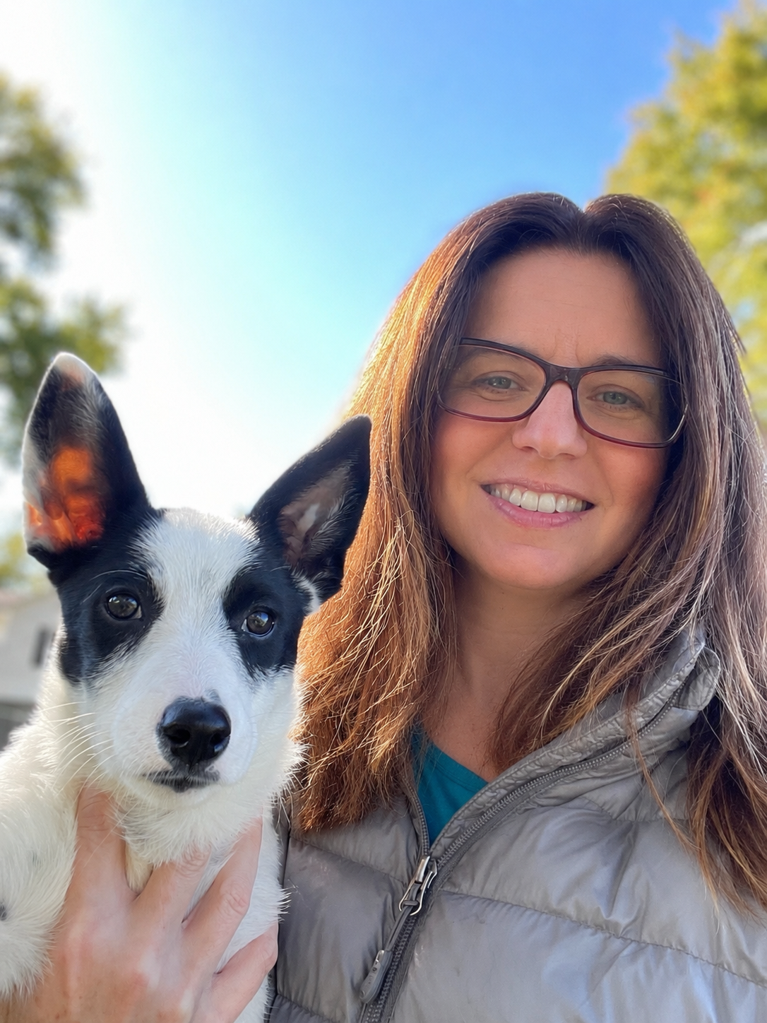 Sarah Filipiak, CDBC, founder of Train Canine, holding a puppy