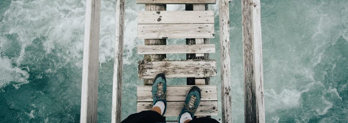 Crossing a scary wooden bridge with raging water underneath