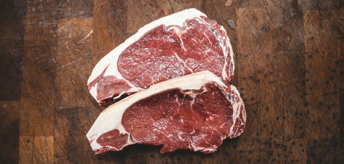 Two steaks on a table.
