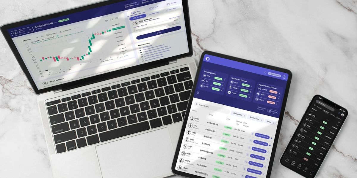 A laptop, tablet and smartphone with charts and investing information.