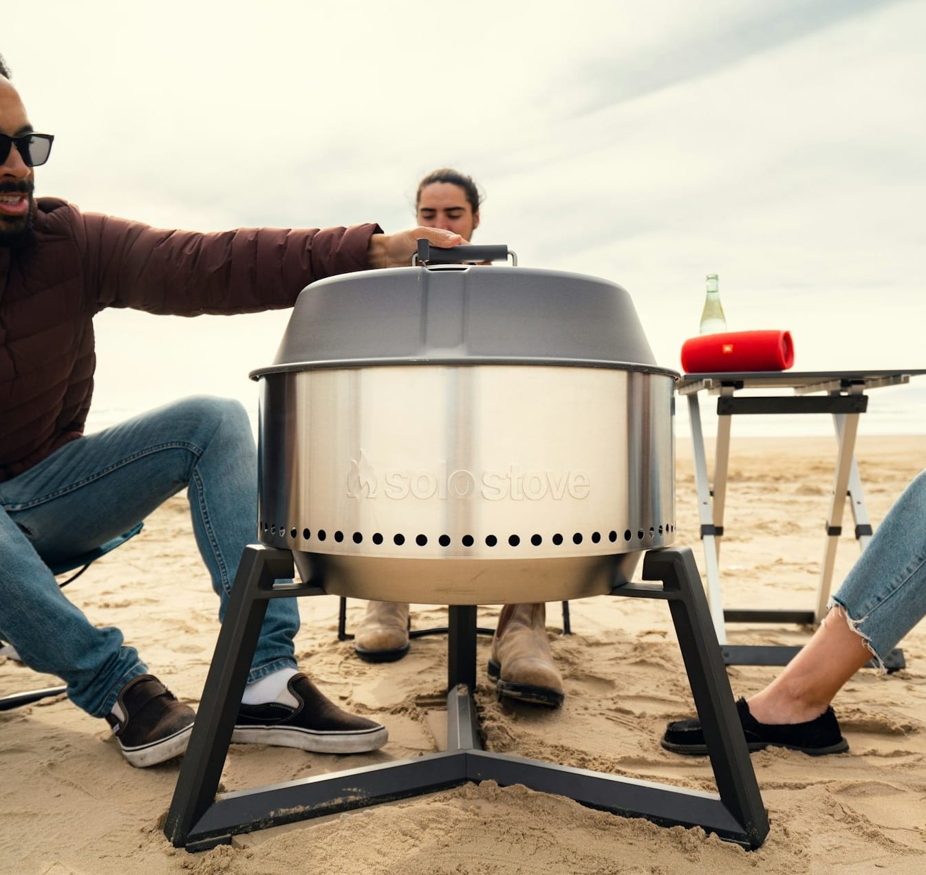 a man and a woman sitting in chairs on the beach
