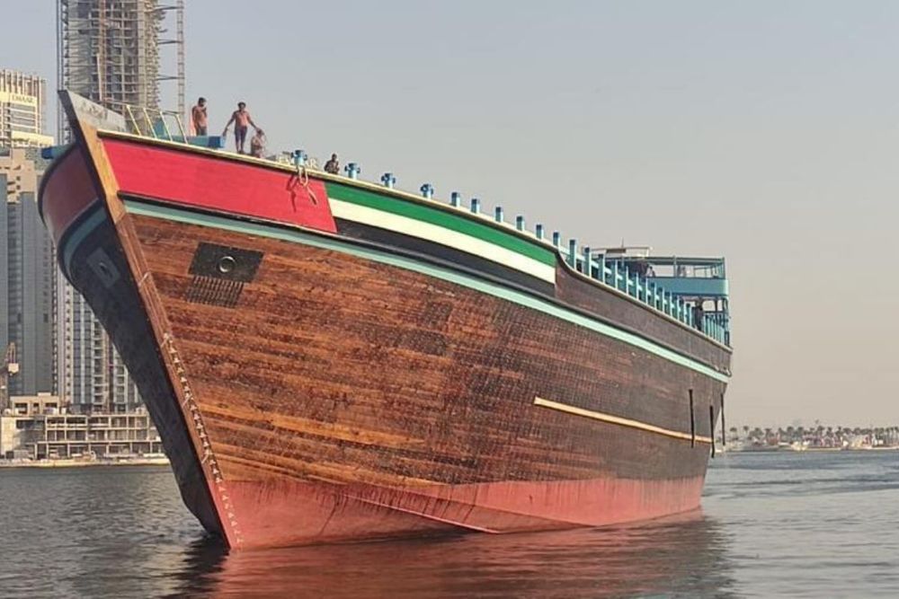 A mighty dhow sails off the shore of Dubai, recognized as the world’s largest