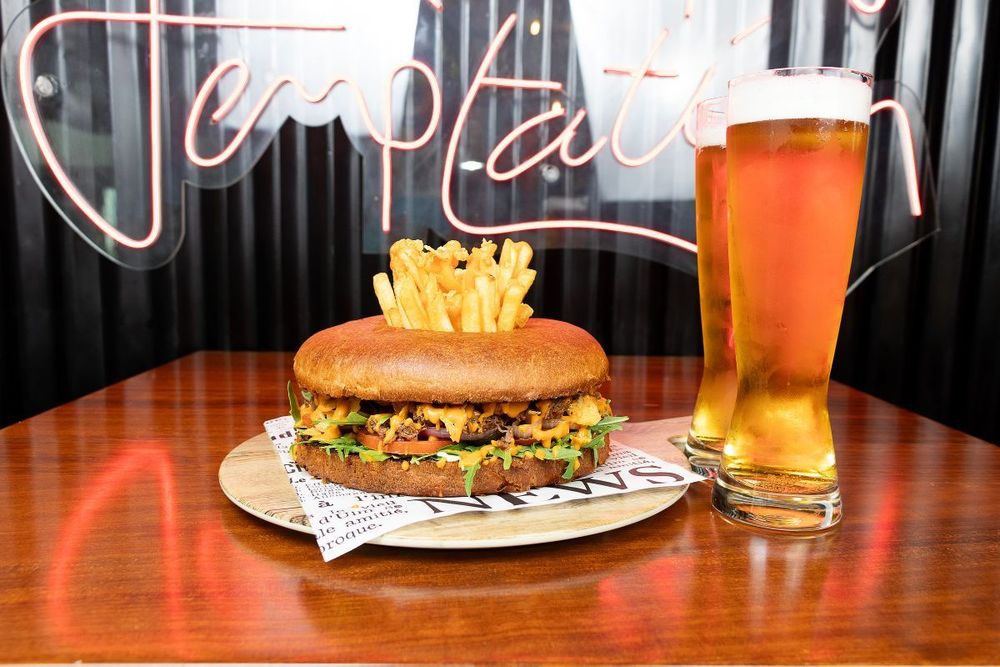 Indulge in a sizzling burger experience at South Central Kitchen Bar & Terrace