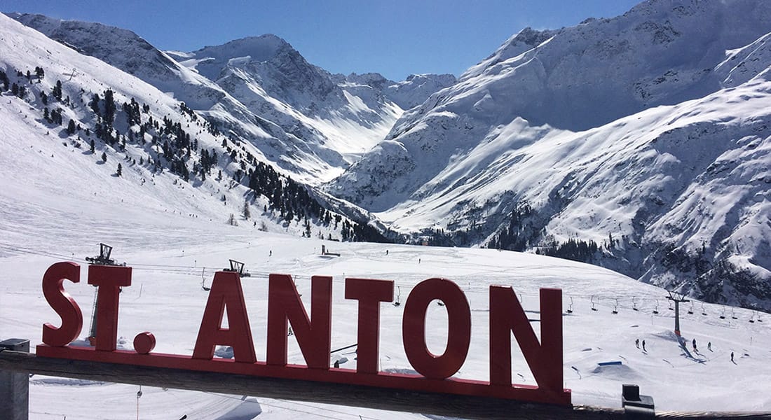 St Anton sign with dramatic mountain scenery behind