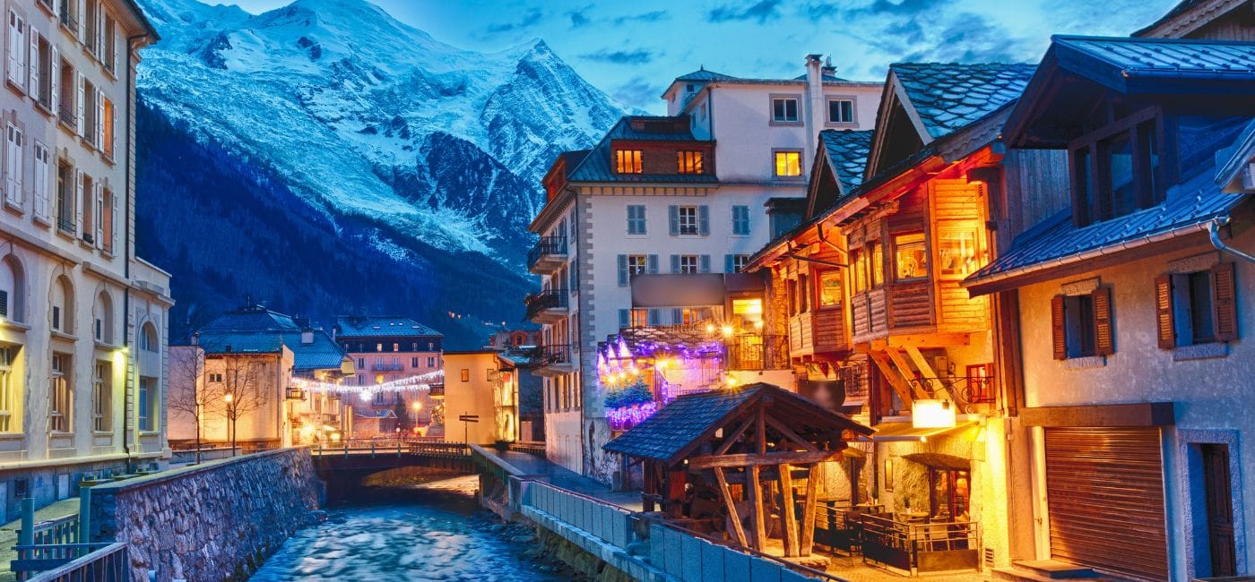 Chamonix river view with bridge and dramatic mountains in backdrop
