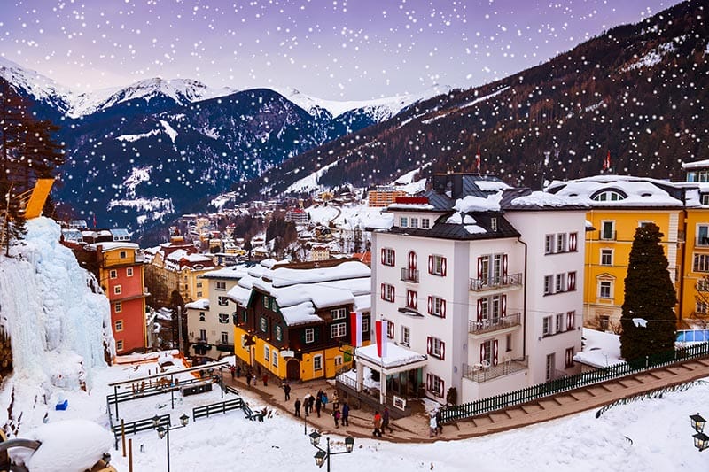 Snow falls over colourful buildings in Bad Hofgastein ski resort