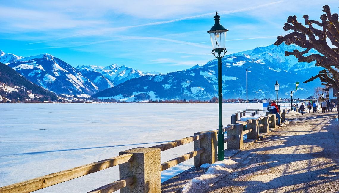 Frozen Lake Zell with people walking round the outside and beautiful backdrop