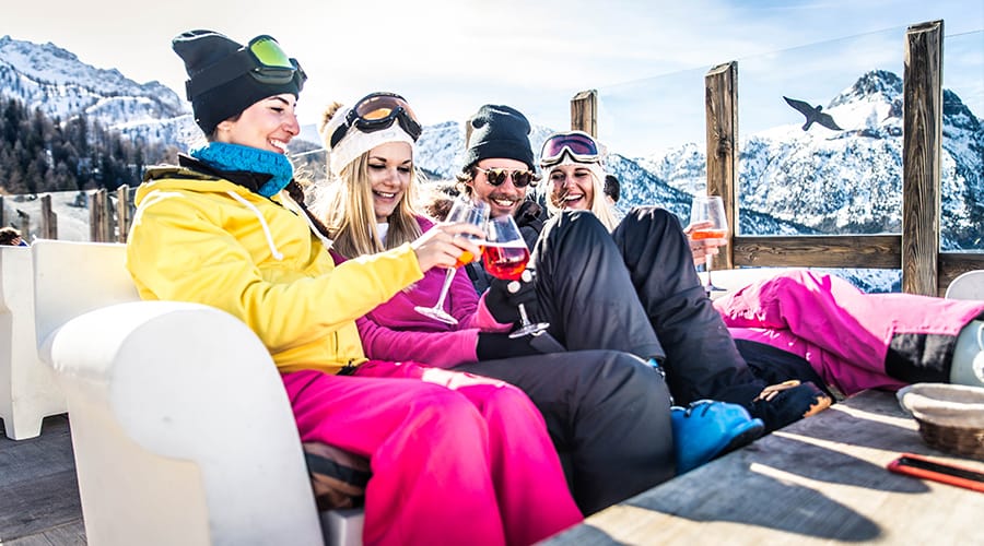 Friends enjoy a drink on a terrace in the mountains