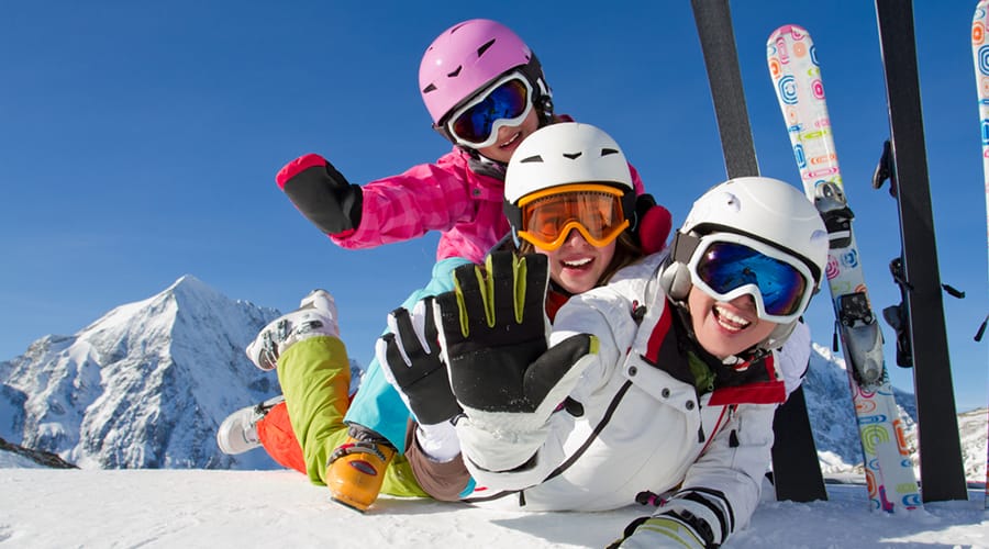 Parents and young daughter have fun on the slopes