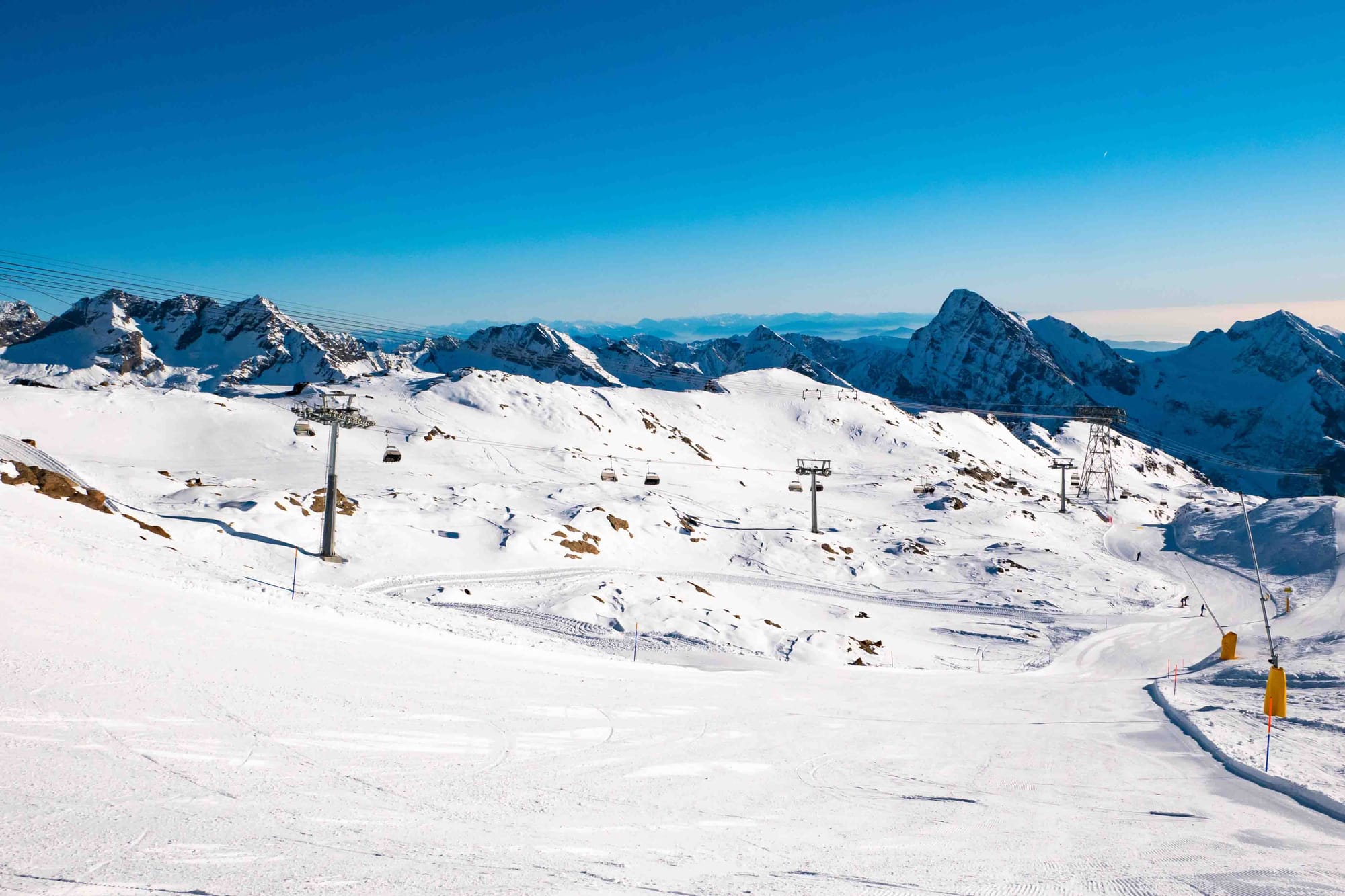 Wide open ski slope in Monterosa with chairlift and blue skies