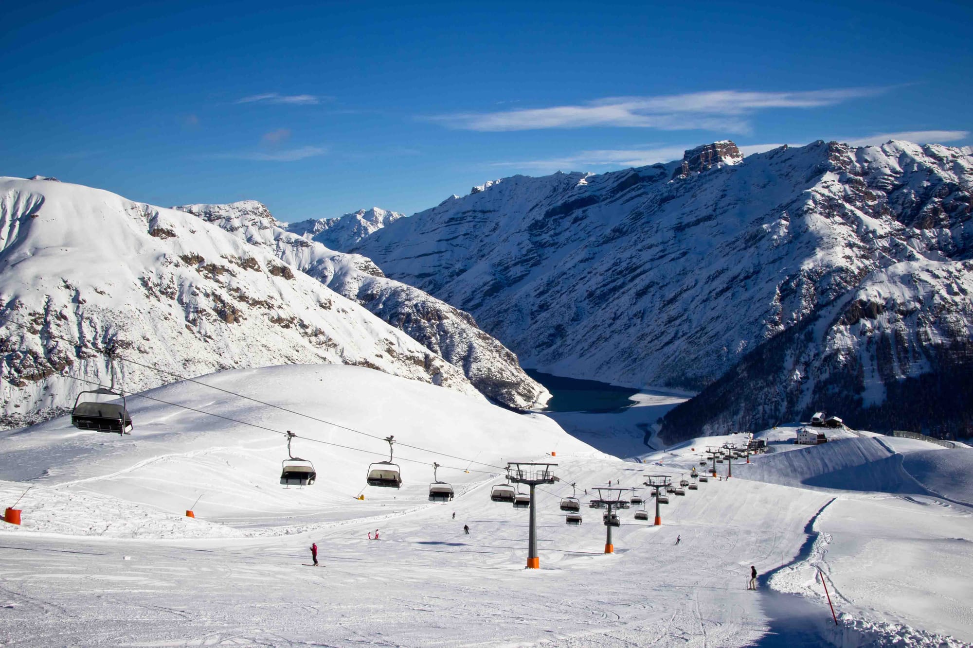 Lovely ski slope in Livigno with chairlift and blue skies
