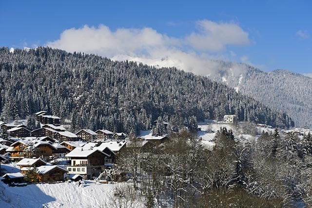 Buildings on mountain side in Morzine with lots of trees