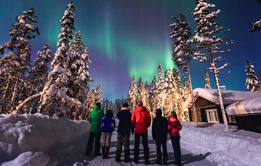 Group of people looking at Northern Lights in Lapland