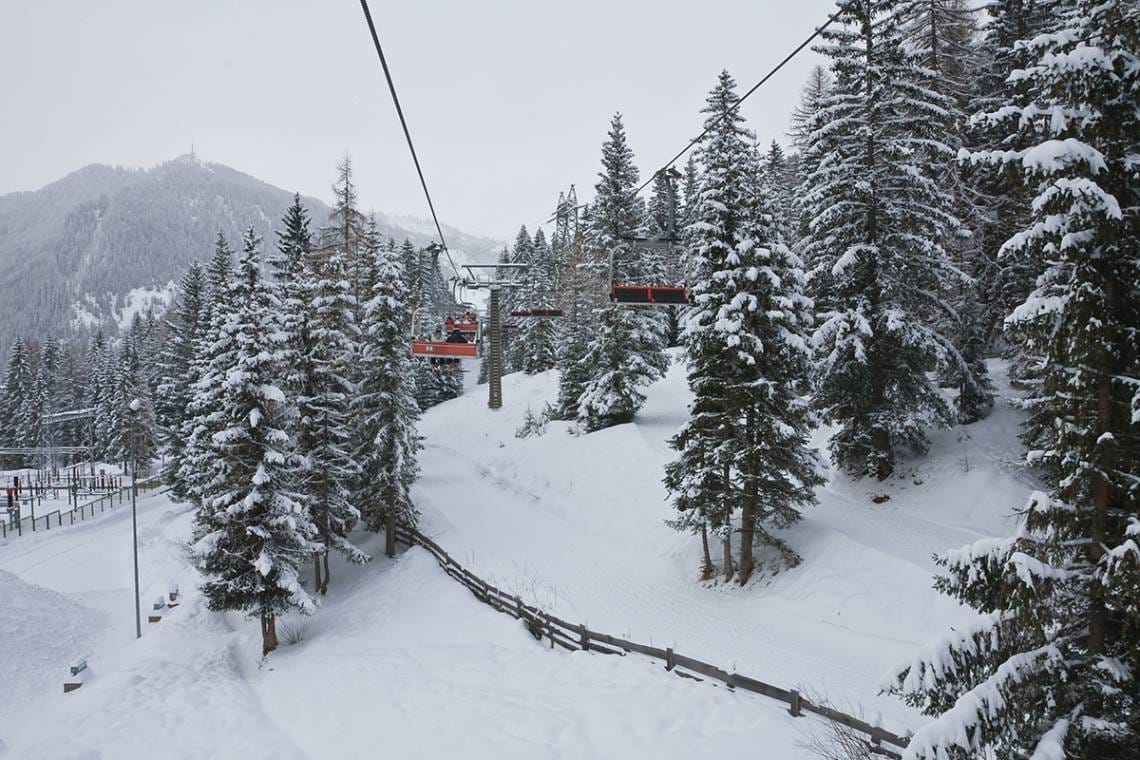 Chairlift through the trees in Selva val Gardena