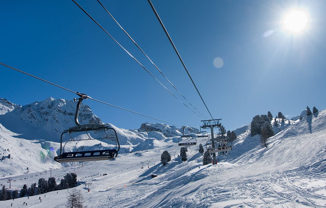 Pristine slopes in La Plagne with chairlift passing over and blue skies