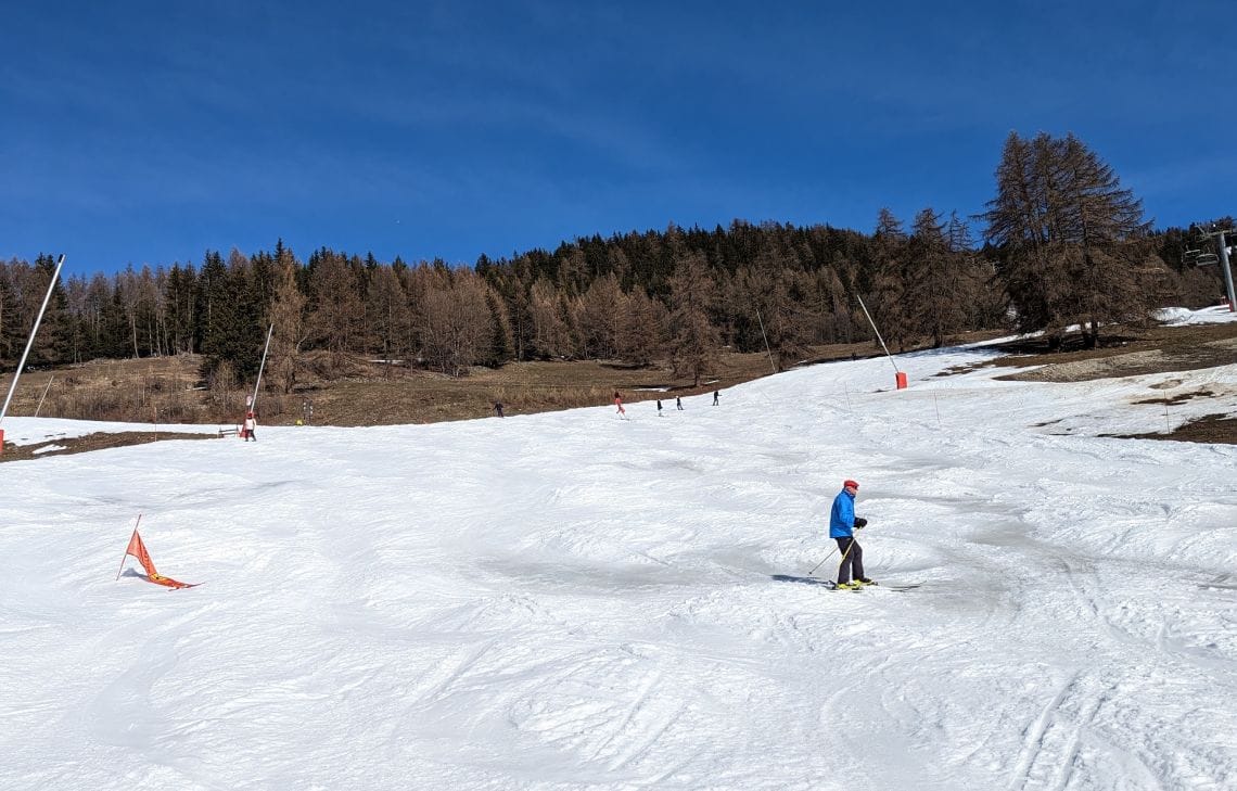 Slope much lower down the mountain where there are patches of slush