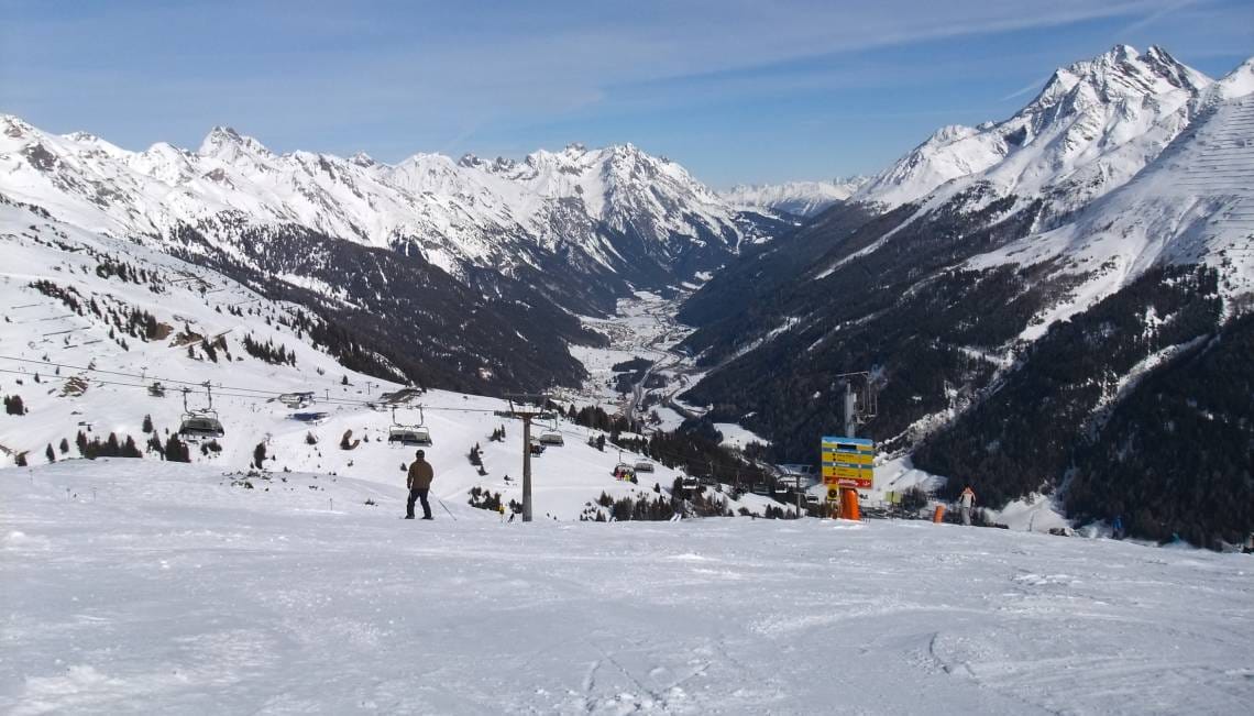 Wide open slopes in St Anton with dramatic valley view behind