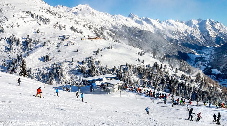Tree skiing in St Anton with skiers boarding a chairlift