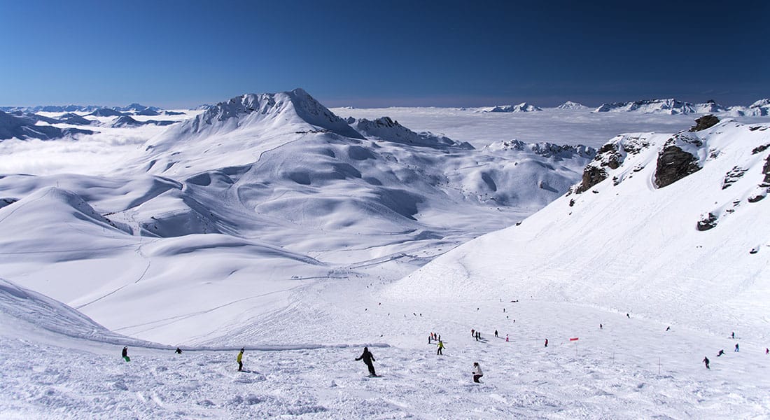 Mogul slope with dramatic view in background