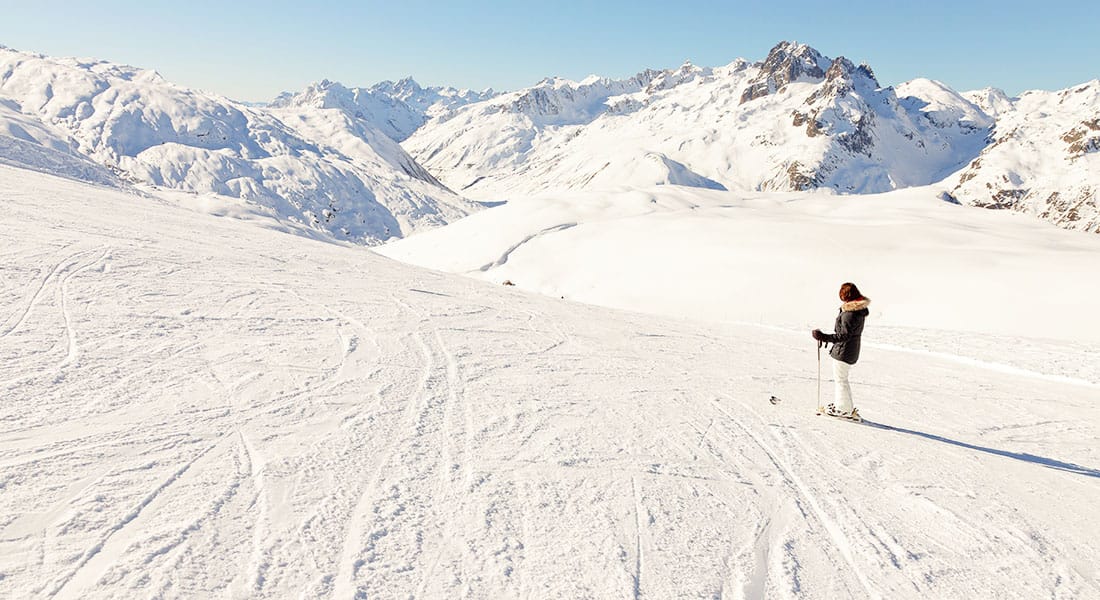 Skier looking down a wide open slope