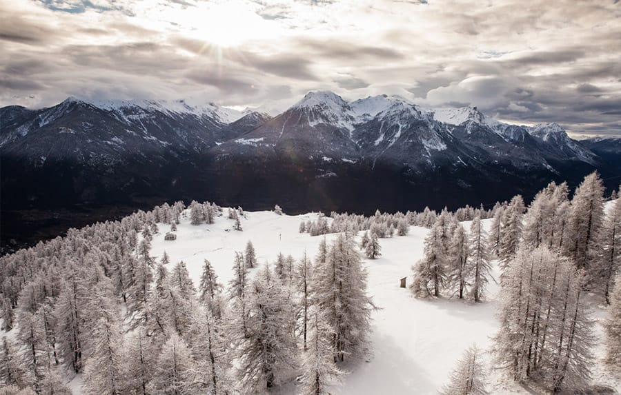 Dramatic mountain scenery in Serre Chevalier with trees and clouds