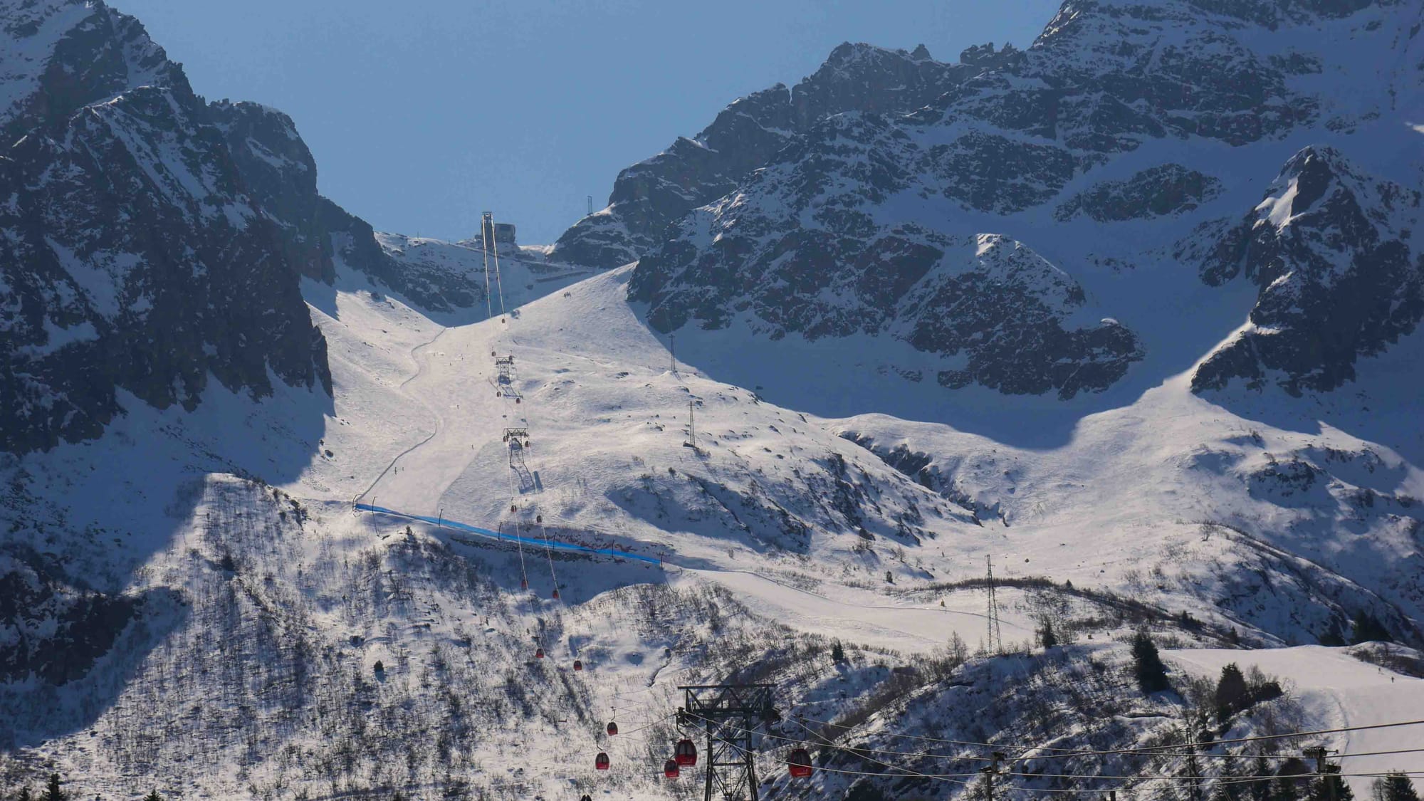 Passo Tonale ski resort with blue skies and dramatic landscape