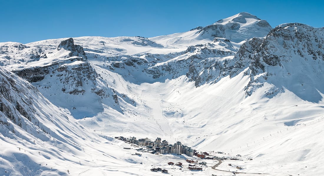 View of Tignes Val Claret from afar with dramatic mountain scenery