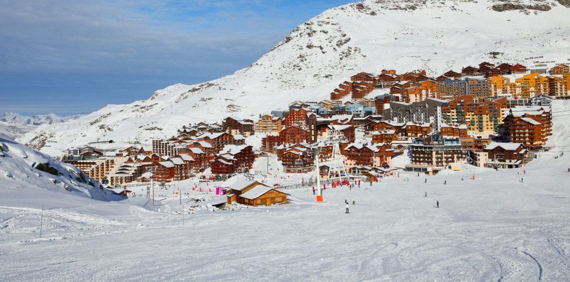 Val Thorens ski resort with blue skies and view from slope leading into it