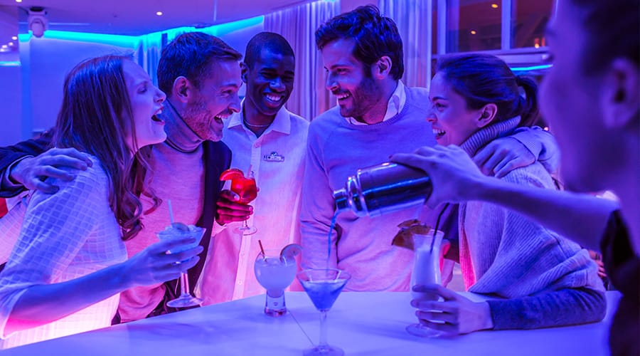 Evening entertainment - 5 people in a huddle enjoying cocktails