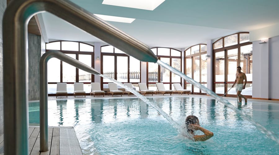 Club Med Pragelato swimming pool with jets shooting water and nice view out window