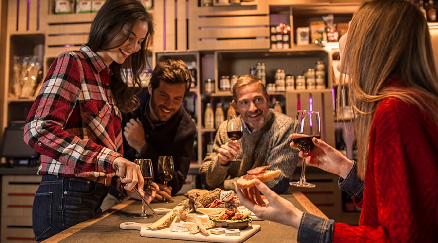 Speciality restaurant in a Club Med - friends enjoying a cheeseboard and wine