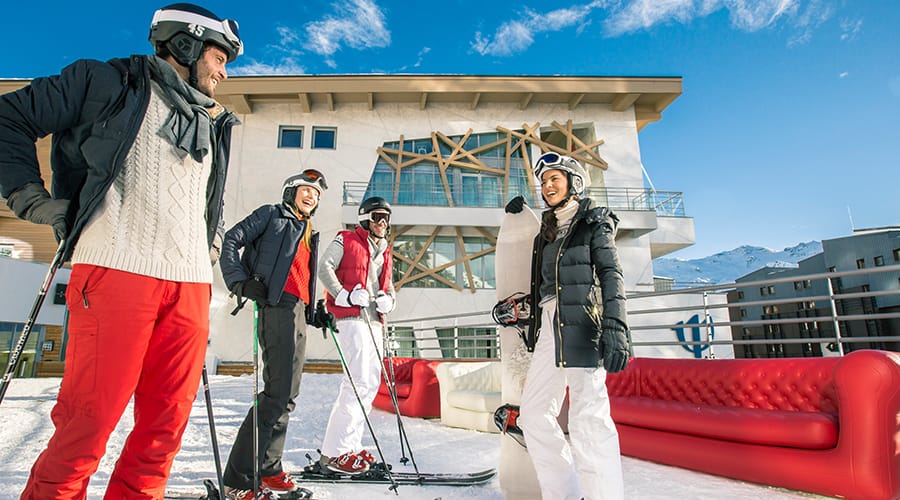 Club Med Val Thorens, with 4 people laughing in conversation outside