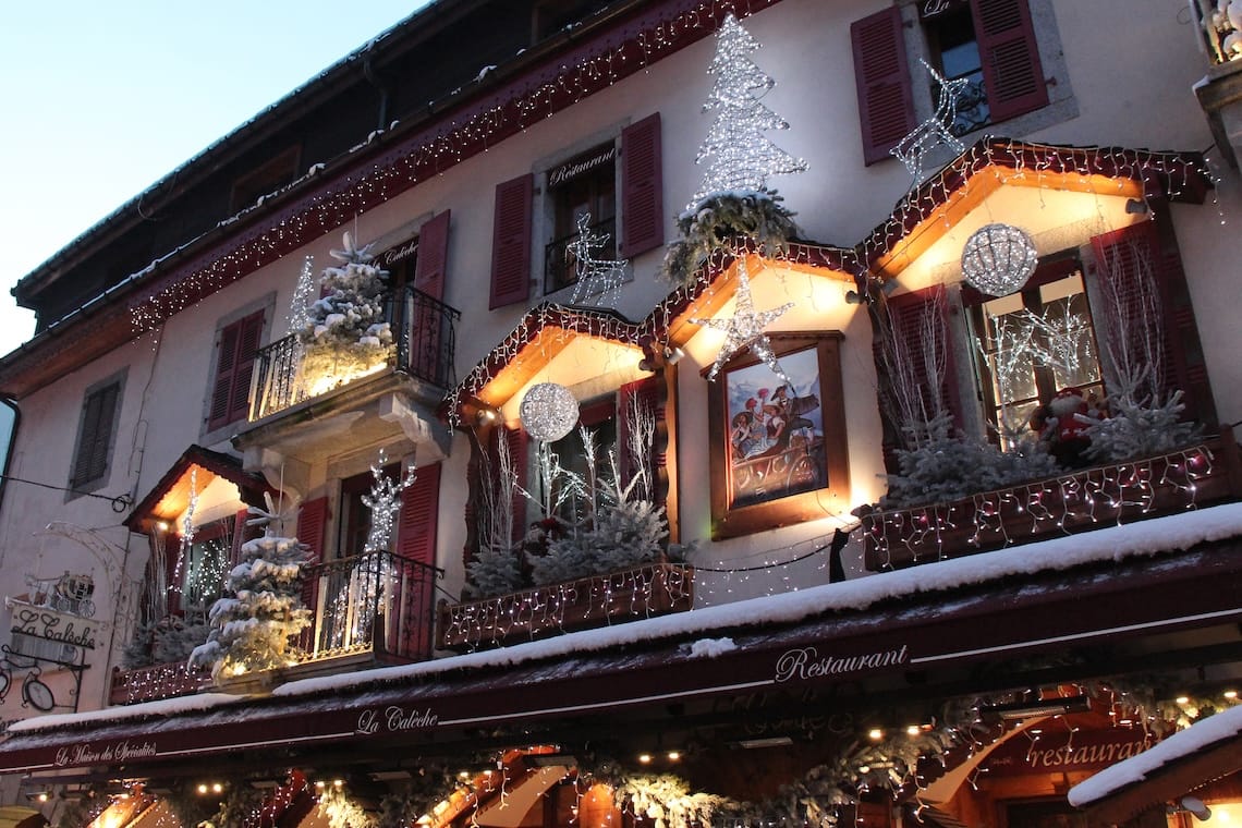 Traditional building in Chamonix decorated with lights and decorations for Christmas