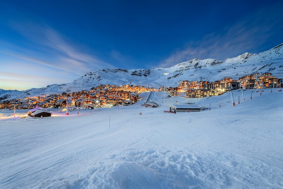 View of lit up Val Thorens ski resort from slopes