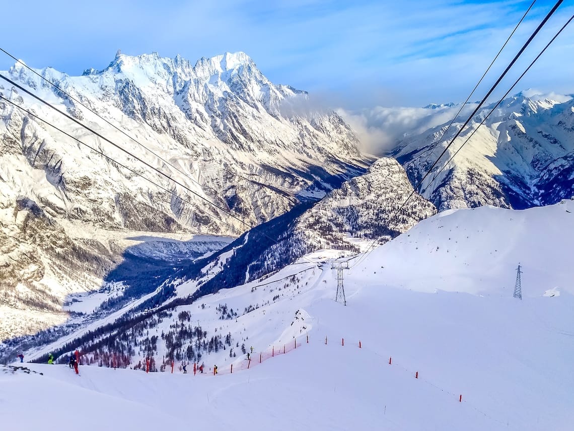 Courmayeur ski resort, Italy, Val d'Aosta aerial panorama with slope and Alps mountain peaks