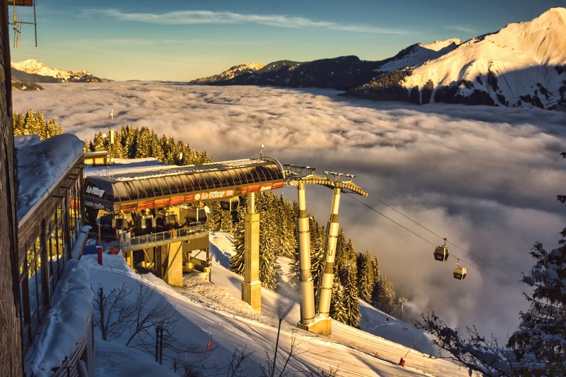 Morzine's Pleney gondola above a cloudy valley floor