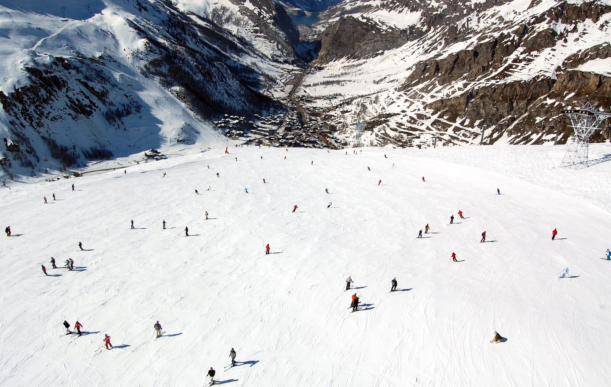 Skiers descend the Face de Bellevarde looking down towards Val d'Isere